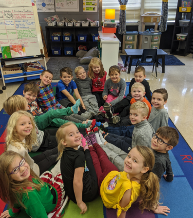 Michelle Slominsky's class gathers in a circle on the floor of her classroom. 