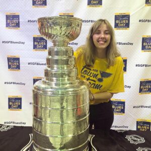 LOGOS Copy Editor for Volume 13 Emma Bishop poses with the Stanley Cup wearing St. Louis Blues gear