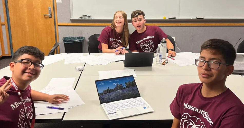 Four students at debate table