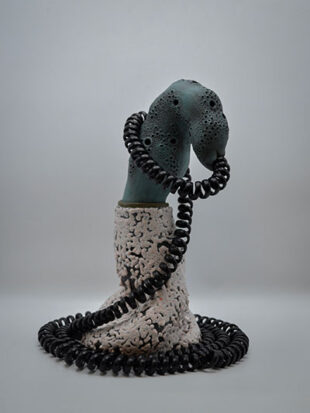 White and green sculpture with telephone cord