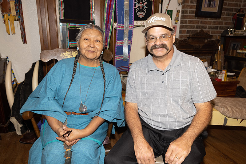 Native American woman sits with male history professor