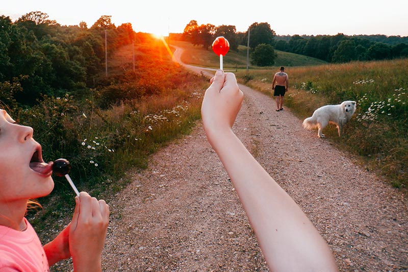 Hand holding lollipop up to the sun