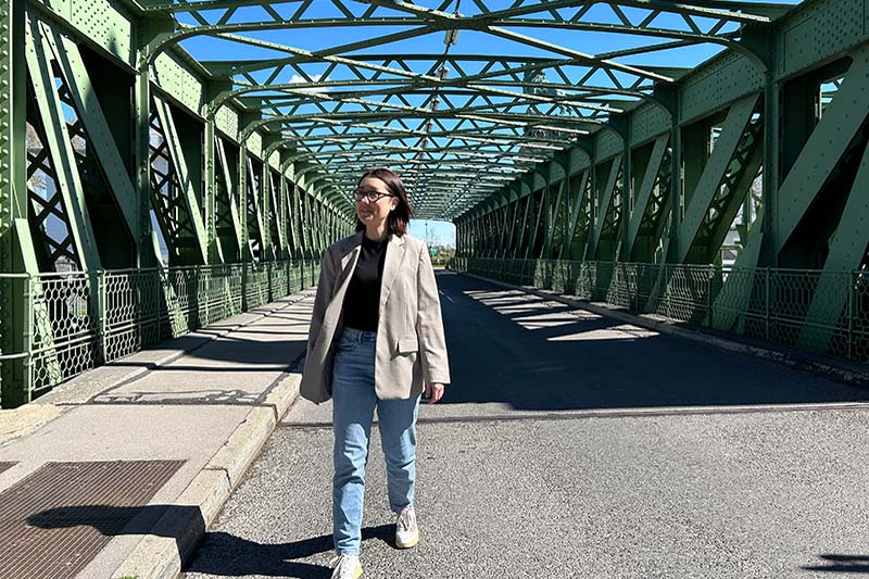 Young woman walks on bridge