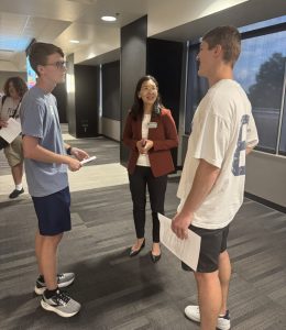 Two students talking with professor