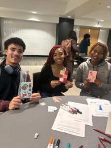 Students holding crafted booklets