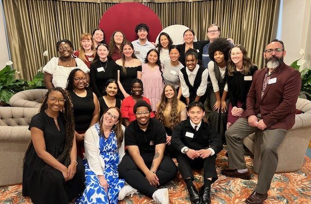 A large group of students & staff members pose for a photo.