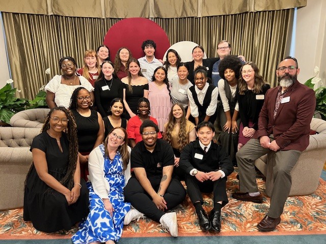 A large group of students & staff members pose for a photo.