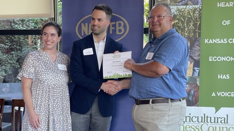Dr. Jim Hutter (right) receives his award from representatives of the Agricultural Business Council of Kansas City.