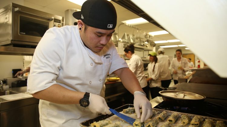 Students prepare food in the Carrie's Café kitchen.