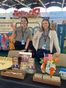 Schott (left) works at a booth.