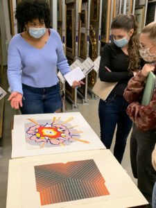 A group of students studying some of the artworks in Springfield Art Museum's vault