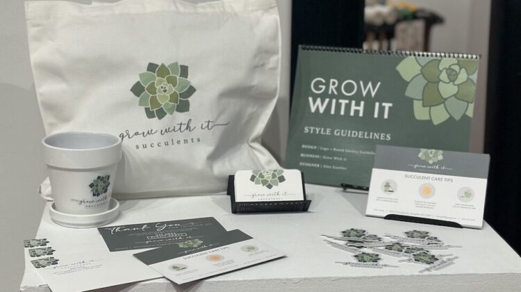 Promotional items with an illustrated succulent logo arranged on a pedestal