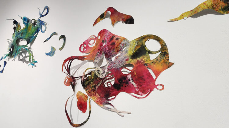 Swirling and colorful paper cut-outs hung on the wall.