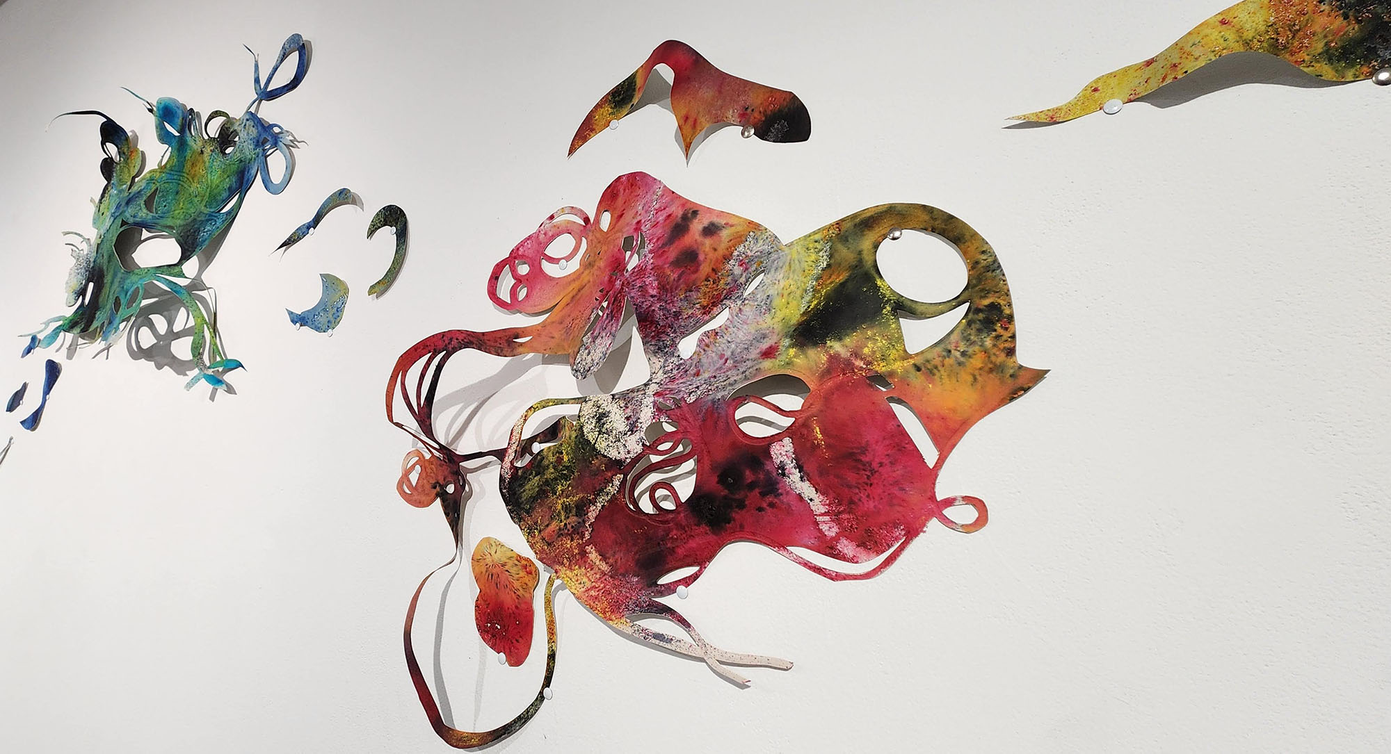 Swirling and colorful paper cut-outs hung on the wall.
