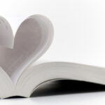 Book with pages curled into a heart