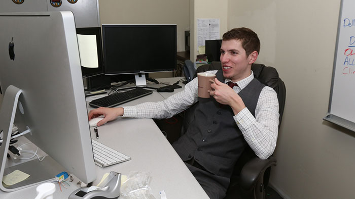 Man at his desk using a computer