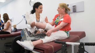 Clinician checking a patient's leg