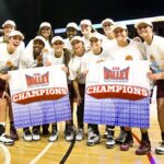 Lady Bears holding "Valley Champions" posters
