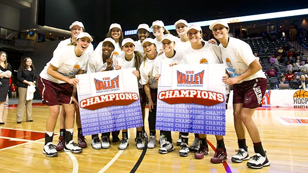 Lady Bears holding "Valley Champions" posters