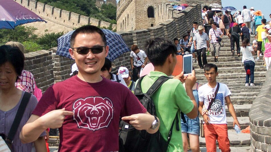 Student in BearWear at the Great Wall of China