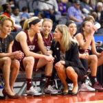Coach Harper talks to girls on bench