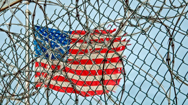 flag behind barbed wire