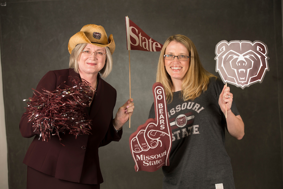Tara and Michelle holding up MSU swag