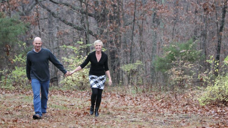 Lisa and Joe Lochner walking in the woods