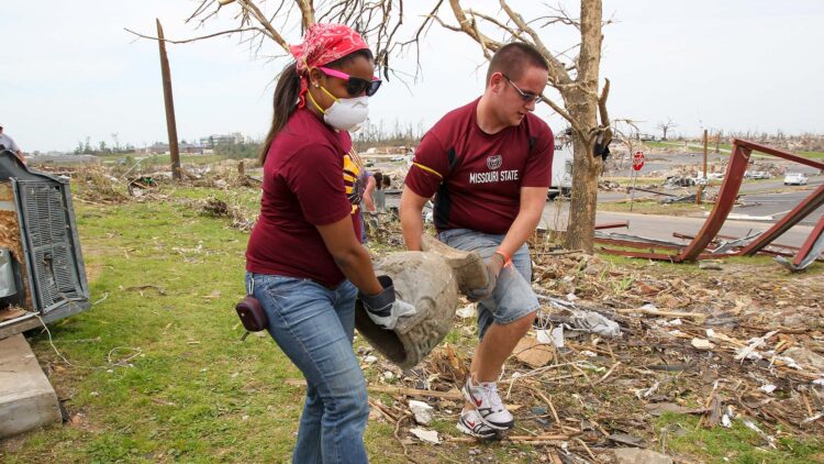 Students clearing debris