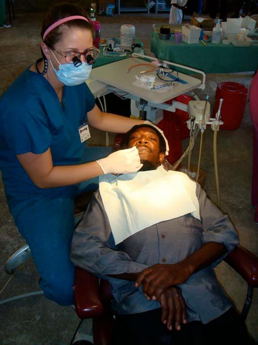 Dr. Ellis in Jamaica working on a patient