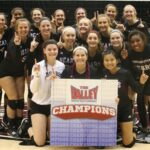 Volleyball team holding up championship sign