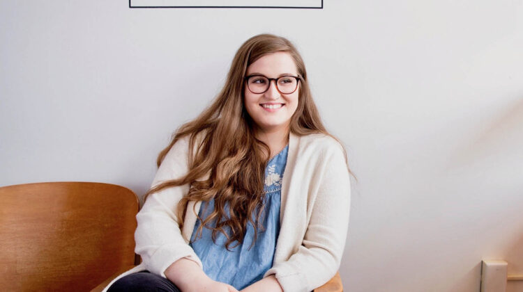 Emma Allman sitting and smiling