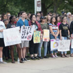 students hold up anti-racism signs