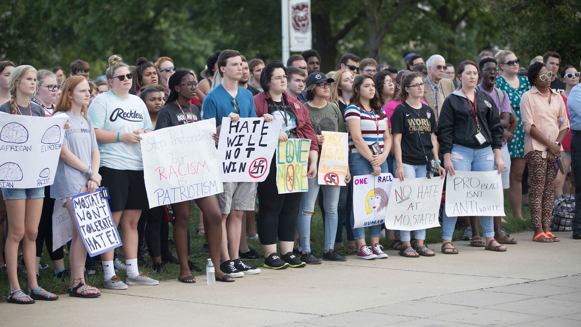 students hold up anti-racism signs
