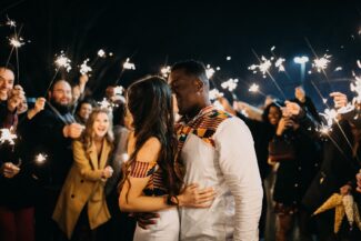 The couple shared their first kiss amidst sparklers and friends