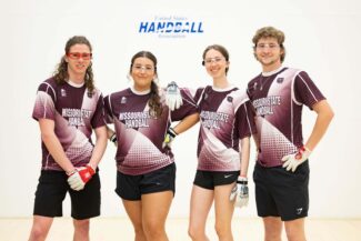Current handball team members pose for a photo at the handball courts.