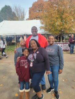Portrait of Aaren Muex and family at MSU Homecoming.