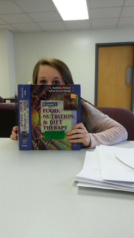Amanda with a nutrition textbook