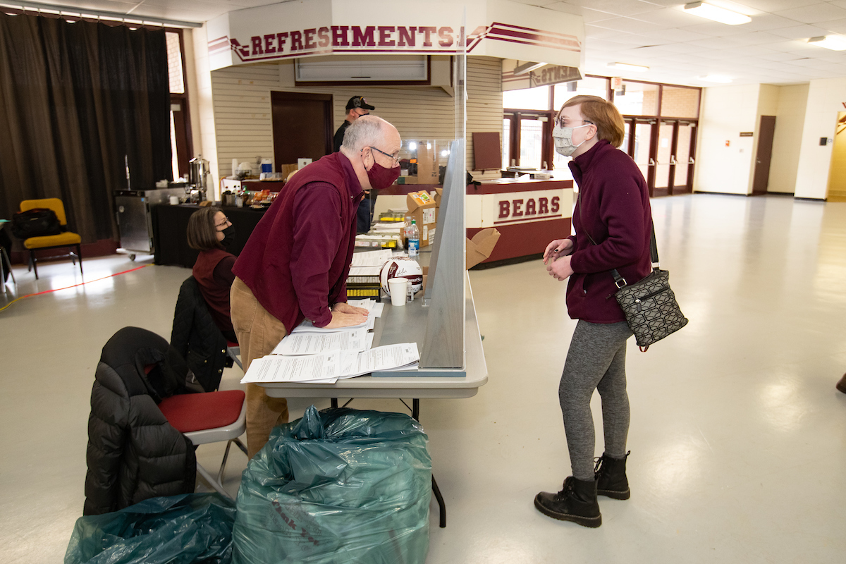 President Smart assists with student check-in for COVID testing.