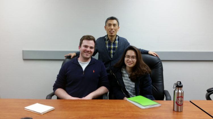 Greg Illy, Dr. Kyoungtae Kim, and Vy Nguyen pose for a photo
