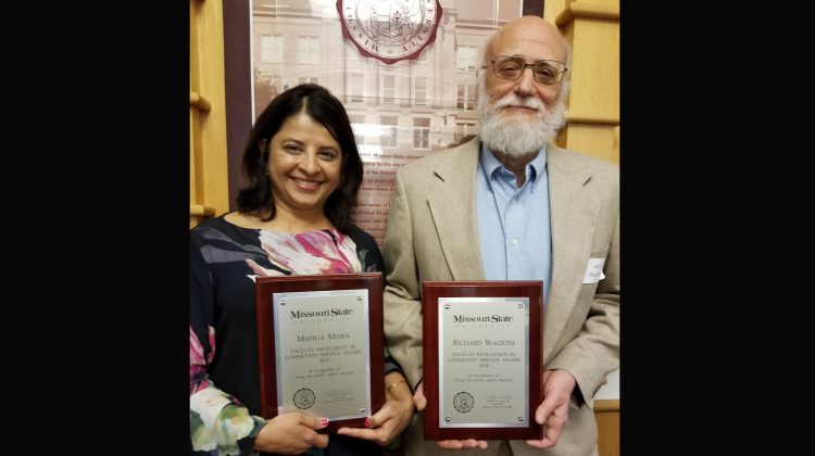 Drs. Mahua Mitra and Richard Biagioni smile with their awards.