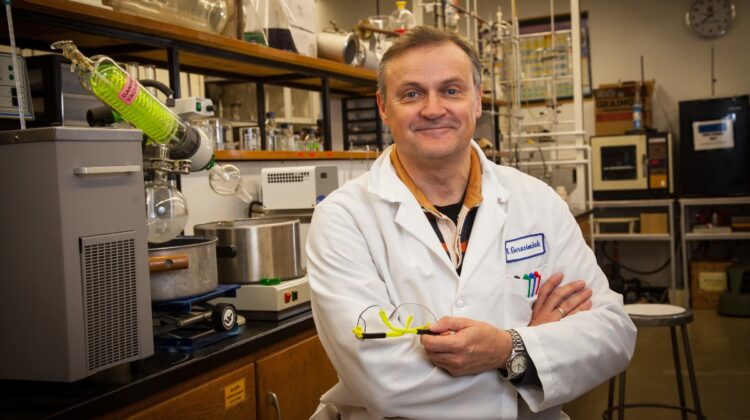 Dr. Nikolay Gerasimchuk poses in his lab surrounded by research equipment.