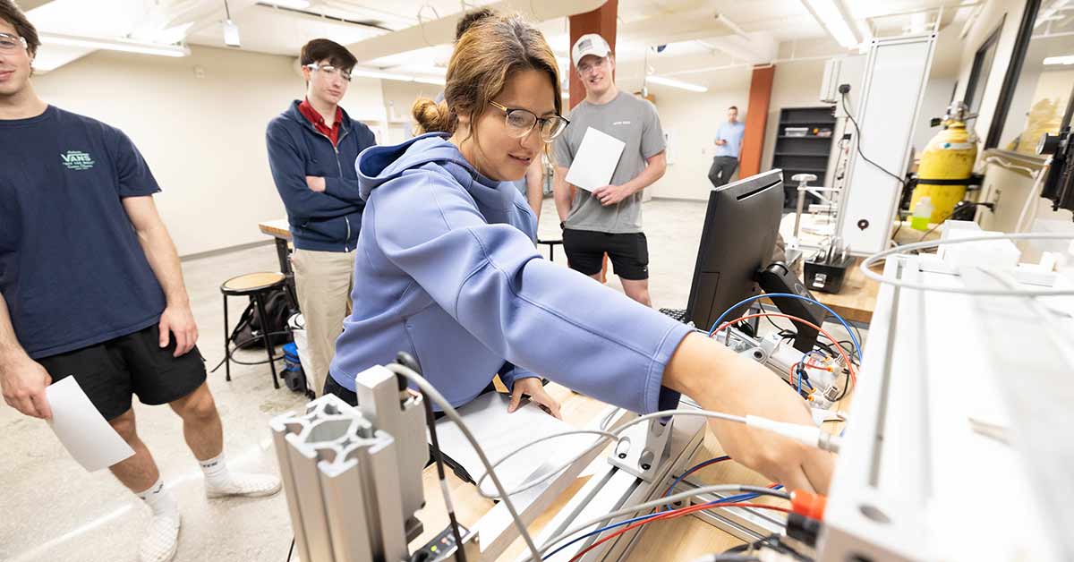 Ana Torres working on mechanical instrumentation during Dr. Ryan Hutcheson's engineering lab.
