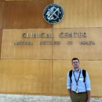 Riley Hochstein standing in front of National Institute of Health Clinical Center