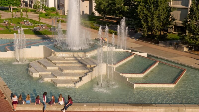 Students sitting by the fountain in front of Blunt Hall