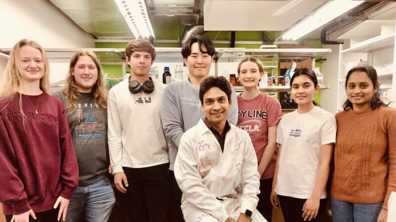 Dr. Santra with students in his research lab.