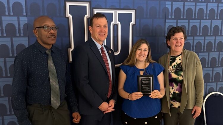 Dr. Natasha DeVore (third from left) with her award. With her (from left to right) are Dr. Adam Wanekaya, department head of chemistry and biochemistry; Dr. Richard B. Williams, Missouri State president; and Dr. Tamera Jahnke, Missouri State interim provost.