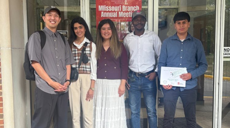 Dr. Takehiro Kado, assistant professor of biology, (far left) with students at ASM branch meeting.