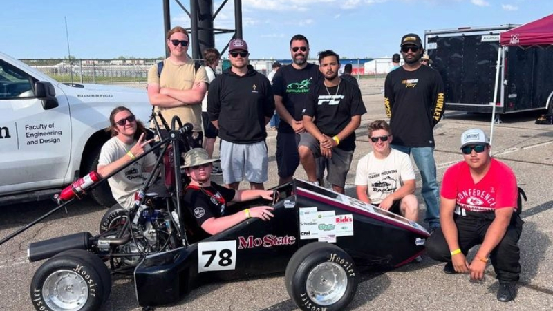 The Missouri State University Formula SAE team with its race car.