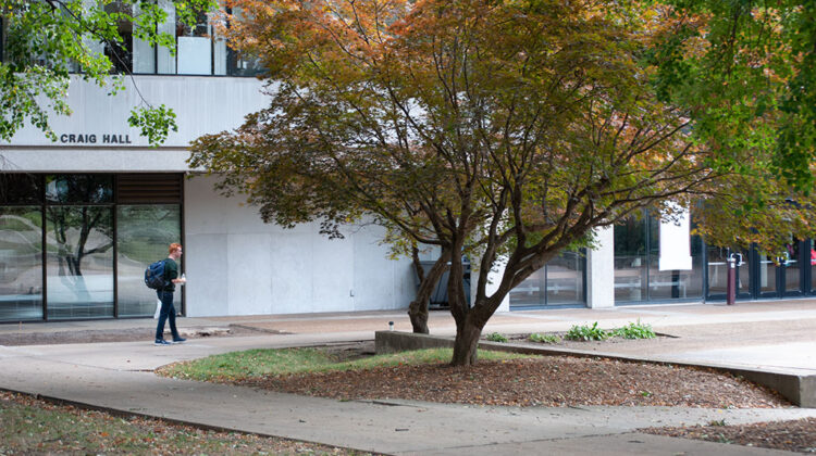 Student walks by Craig Hall on campus of Missouri State University